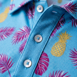 Cream of the Crop blue Hawaiian polo shirt — fabric and pineapple print close-up detail
