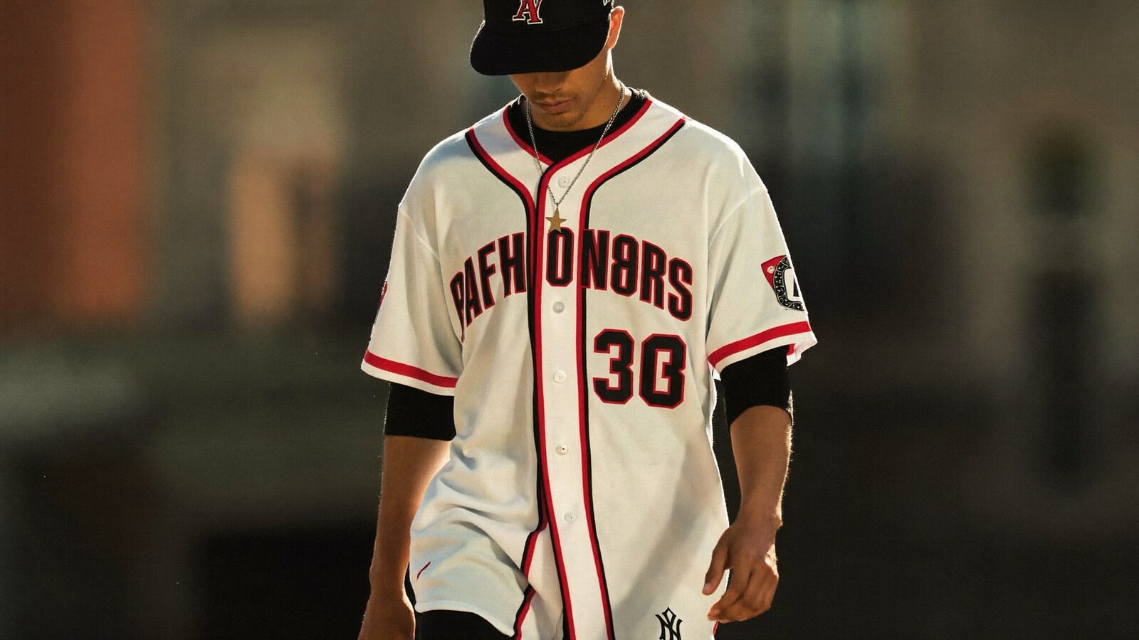 Person wearing an anime-inspired baseball jerseys in an editorial scene