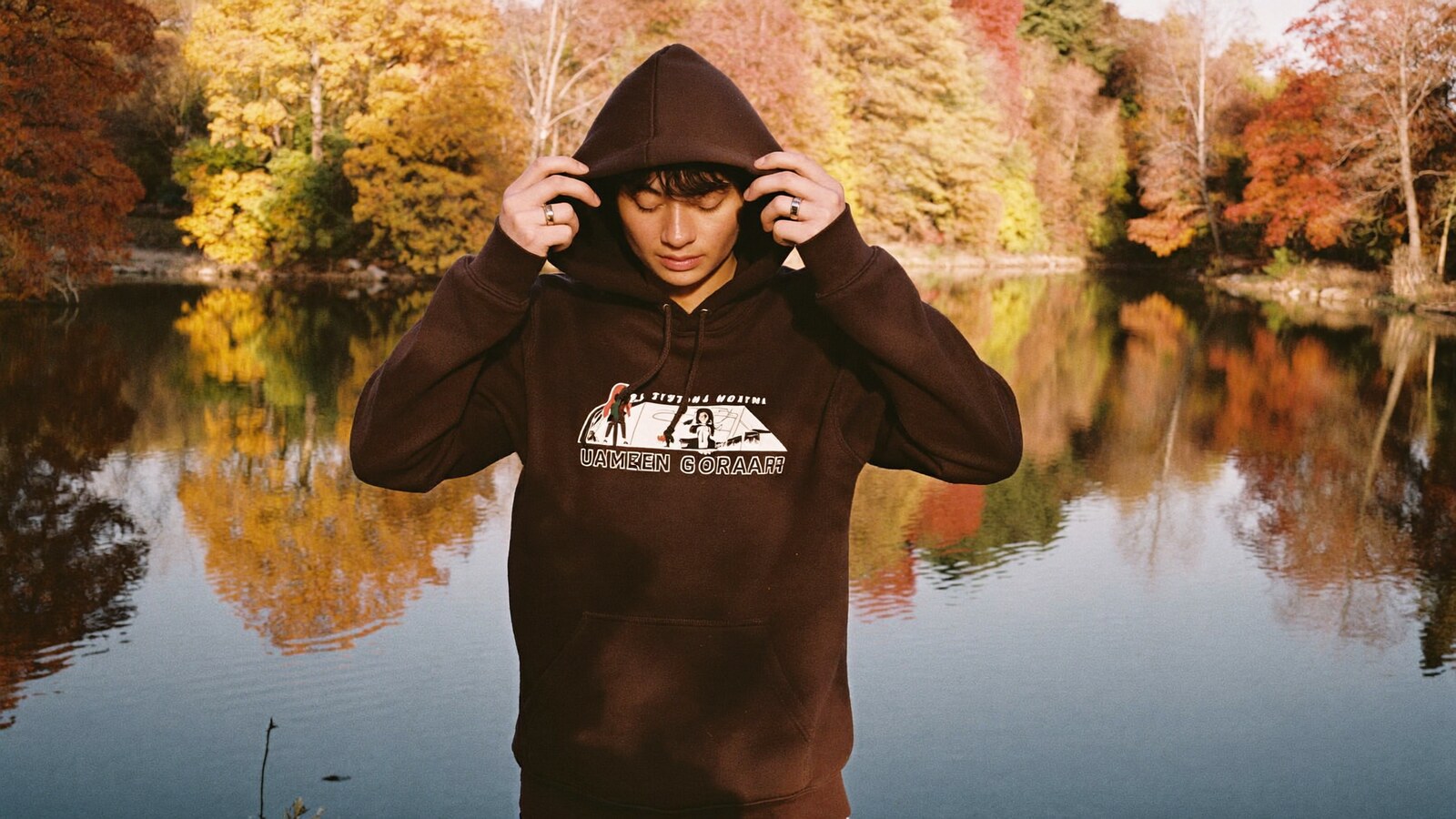 Anime-inspired embroidered hoodie styled in a natural daylight scene