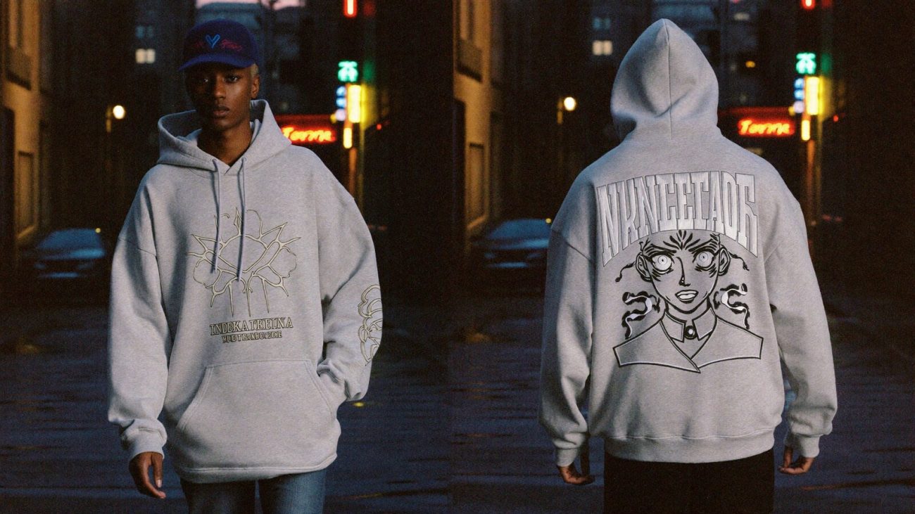 Person wearing an anime-inspired embroidered hoodie in an editorial scene