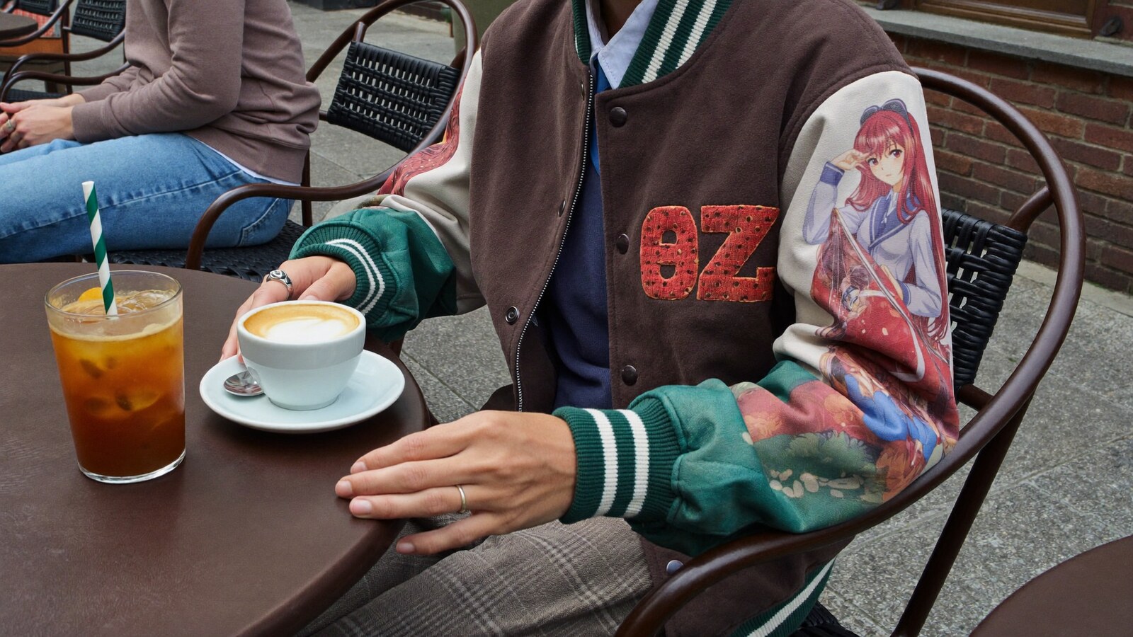 Anime-inspired varsity jackets styled in a natural daylight scene