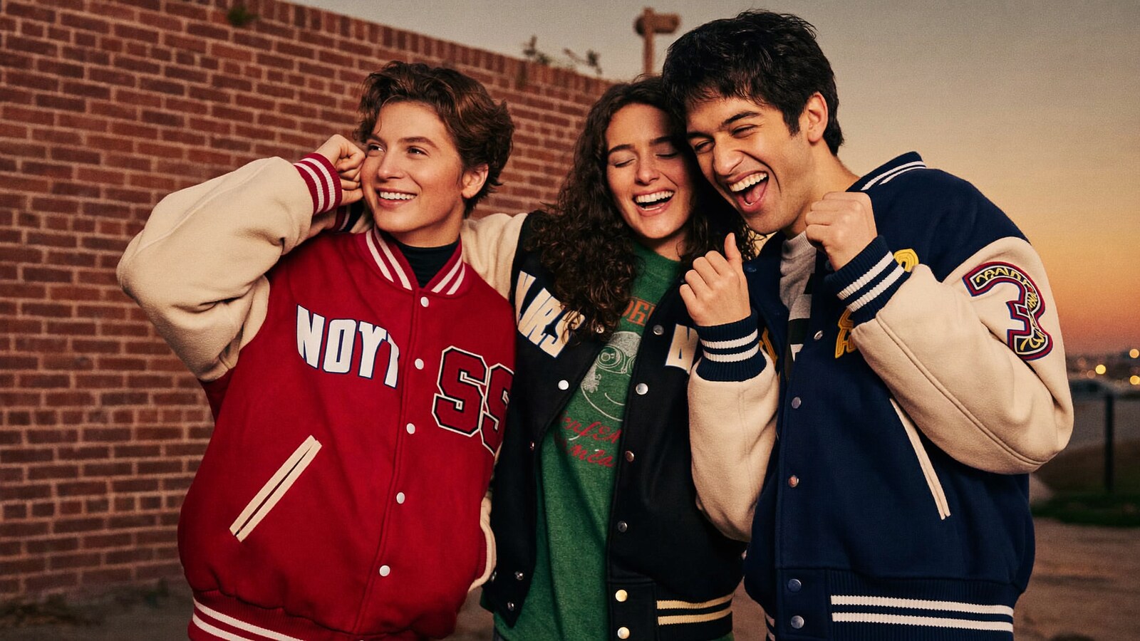 Anime-inspired varsity jackets in a social or layered scene with friends
