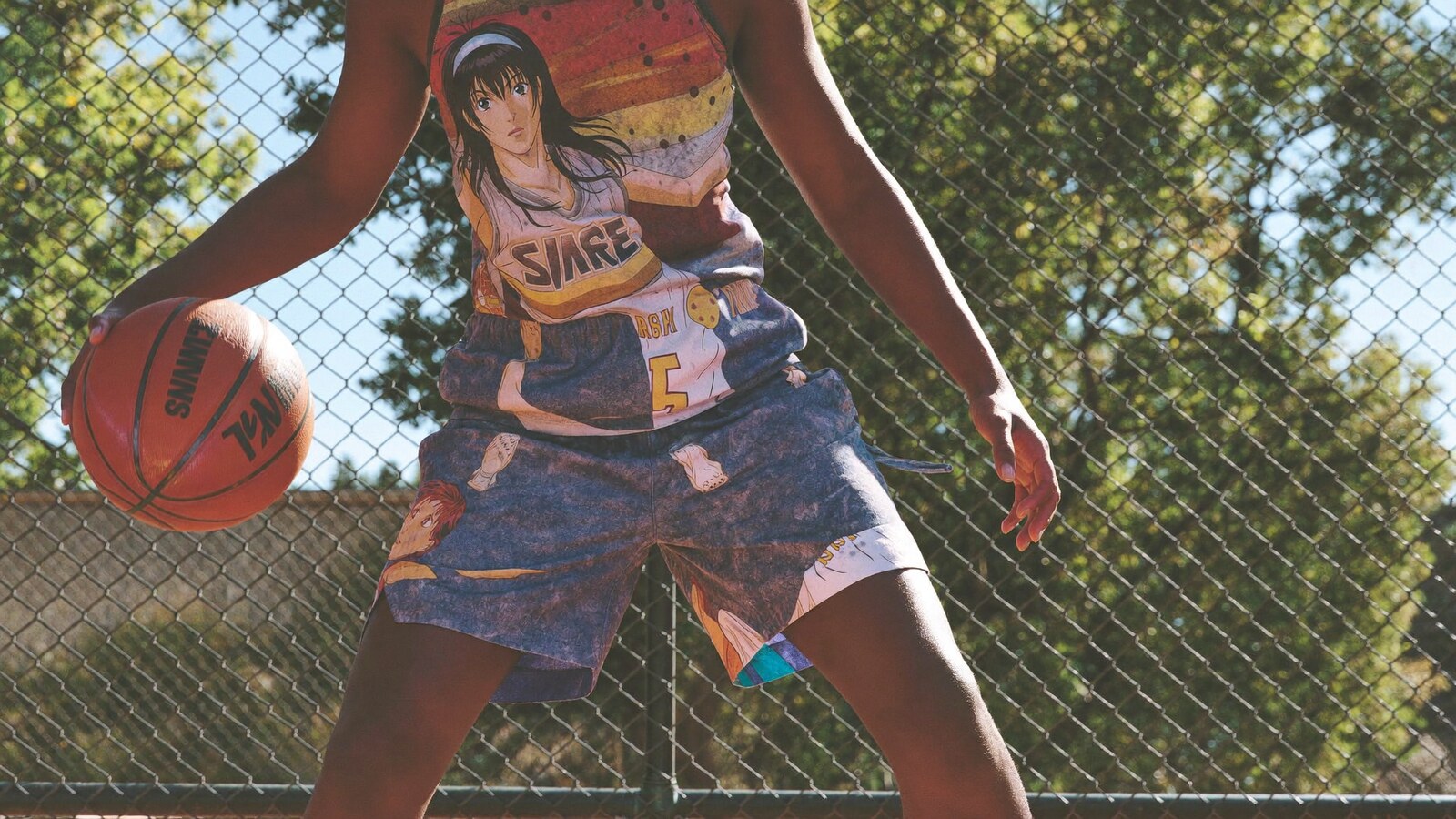 Person wearing an anime-inspired basketball shorts in an editorial scene