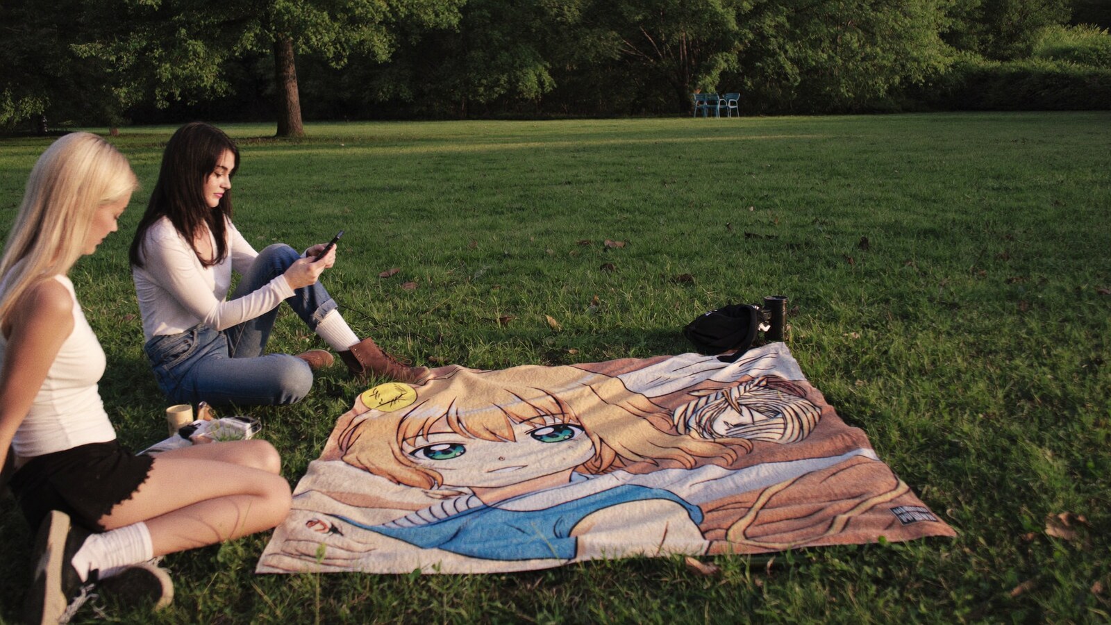 Anime-inspired blanket in a social or layered scene with friends