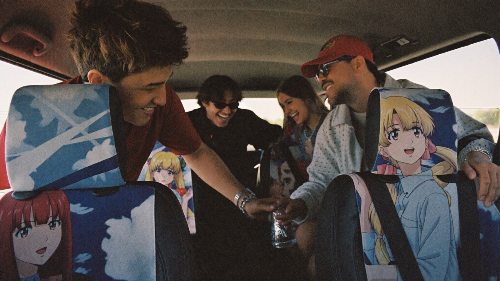 Anime-inspired car seat covers in a social or layered scene with friends