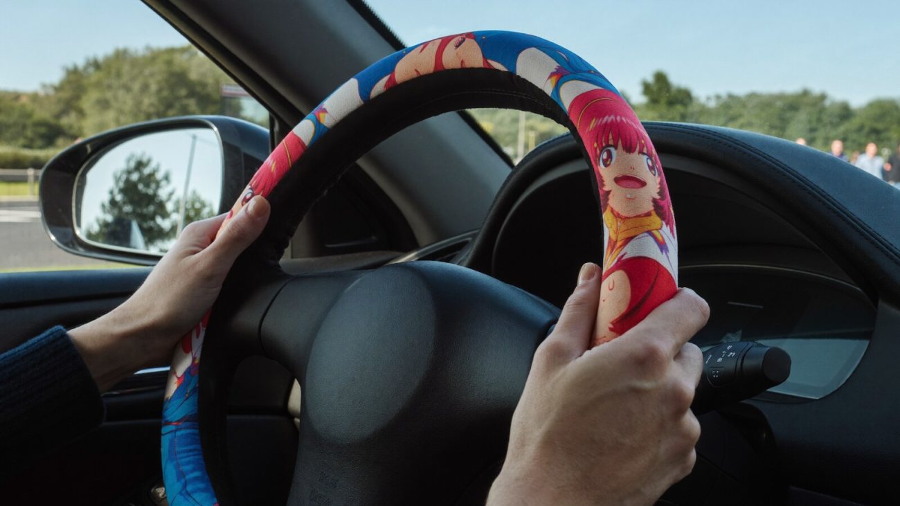 Anime-inspired car steering wheel cover styled in a cinematic scene