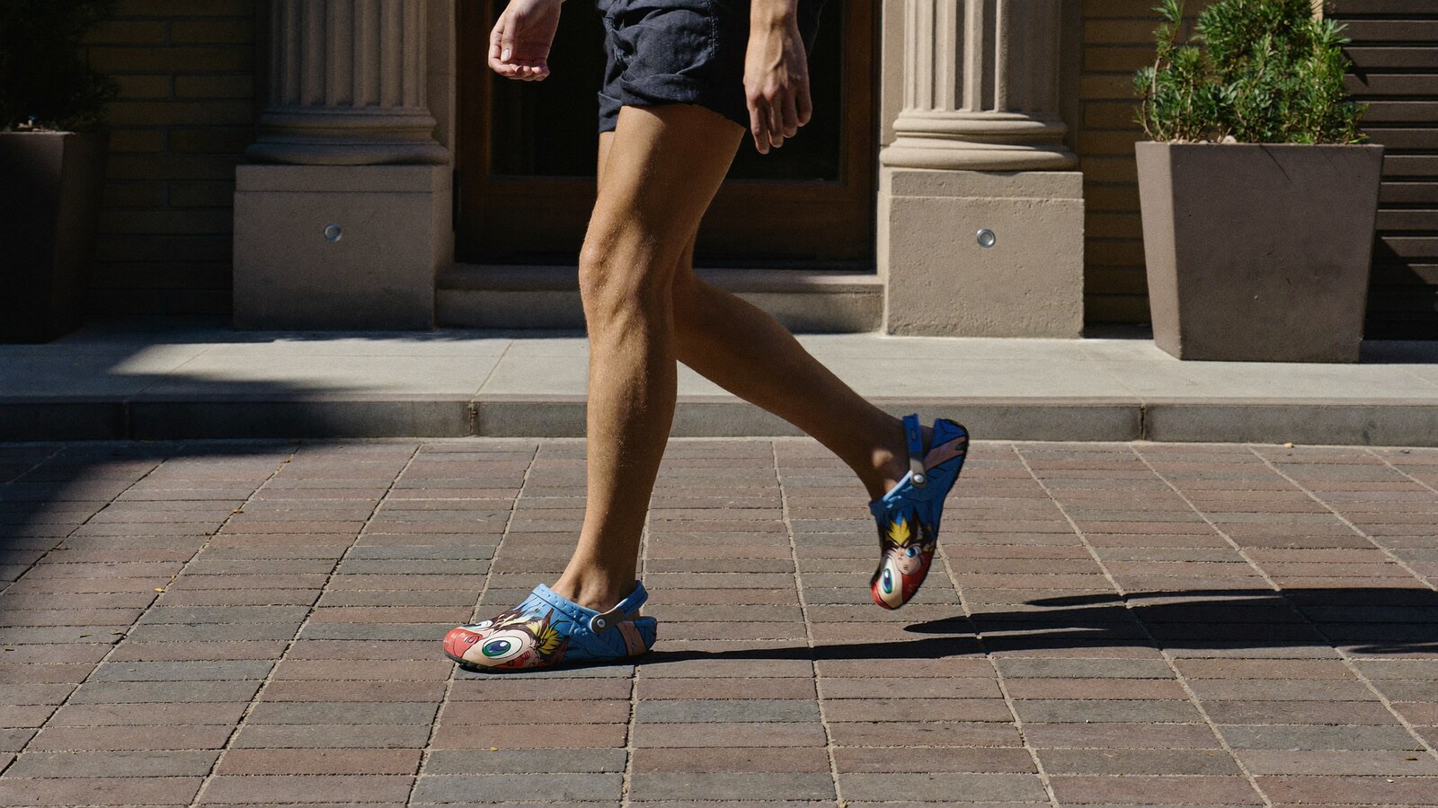 Person wearing an anime-inspired clogs in an editorial scene