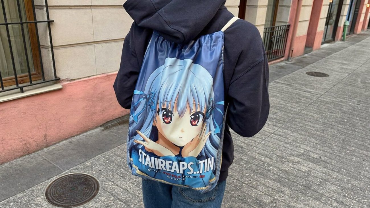 Person wearing an anime-inspired drawstring bags in an editorial scene