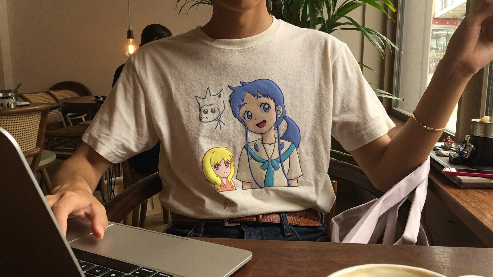 Anime-inspired embroidered t shirt styled in a natural daylight scene