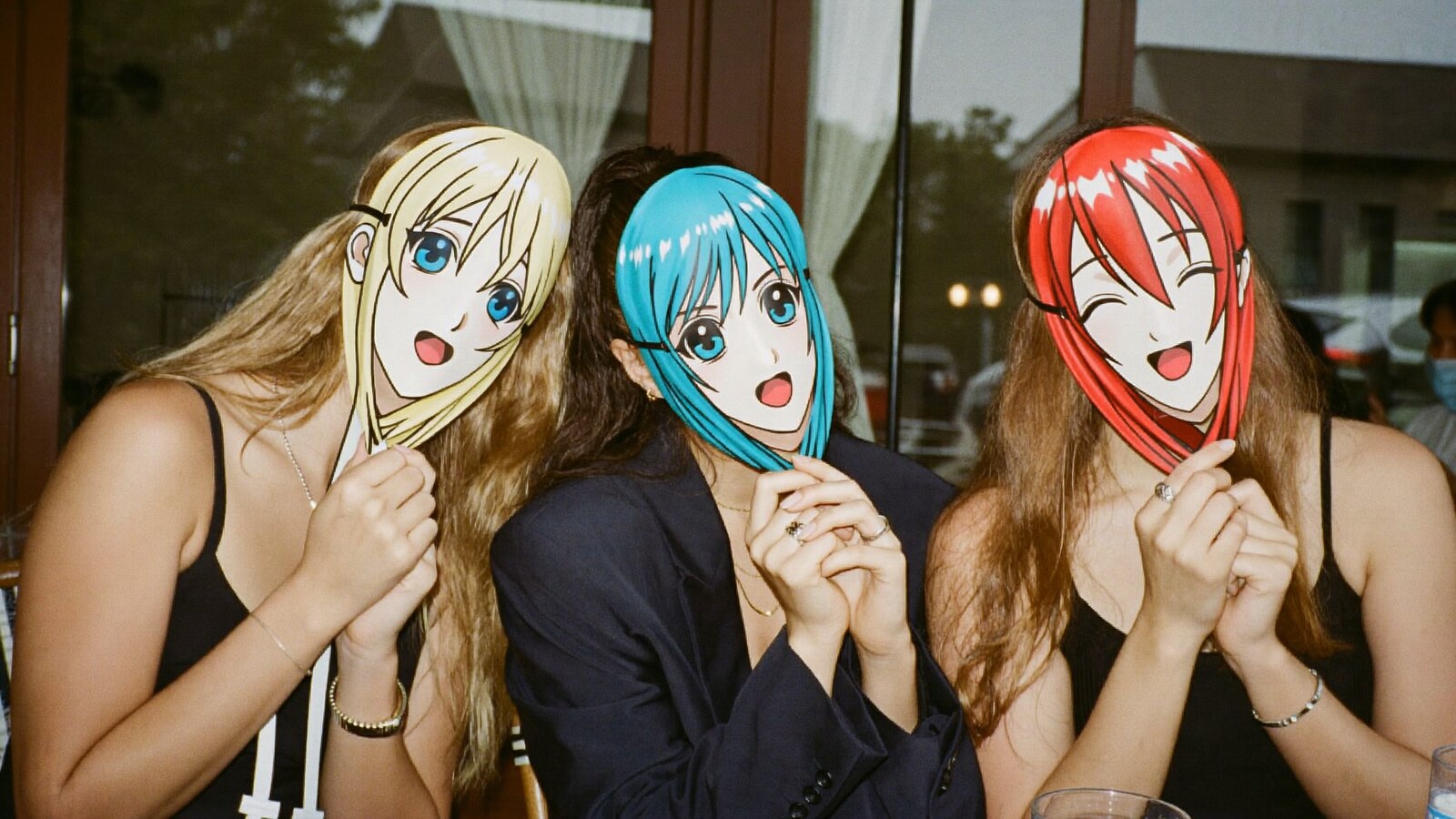 Anime-inspired face masks in a social or layered scene with friends