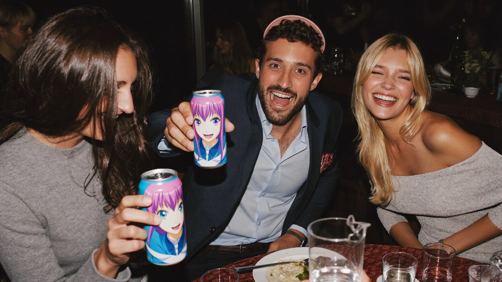 Anime-inspired glass can in a social or layered scene with friends