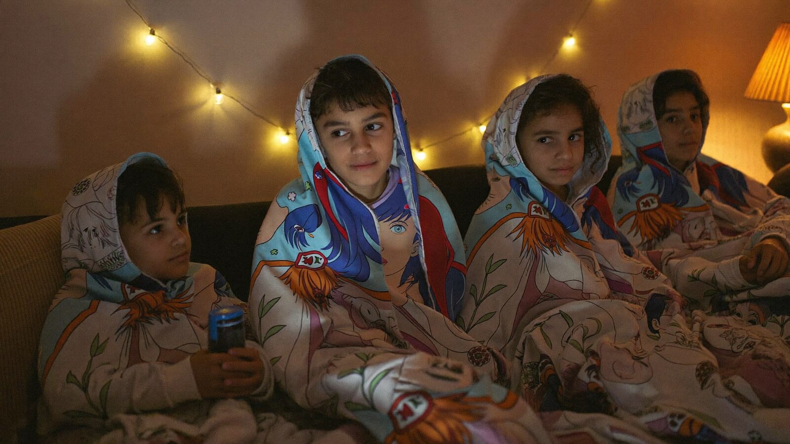 Anime-inspired hooded blankets in a social or layered scene with friends