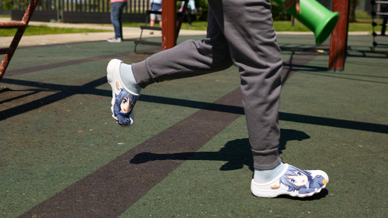 Person wearing an anime-inspired kids clogs in an editorial scene