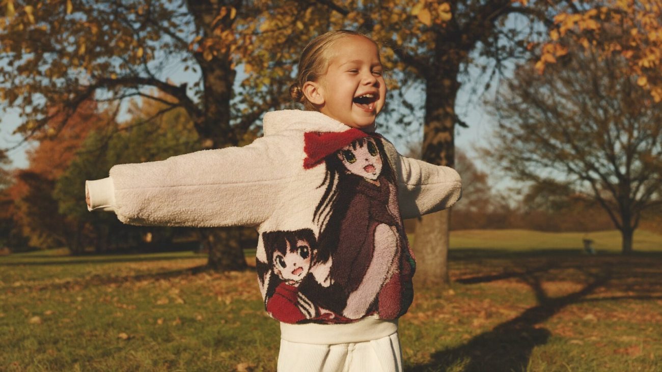 Person wearing an anime-inspired kids hoodie in an editorial scene