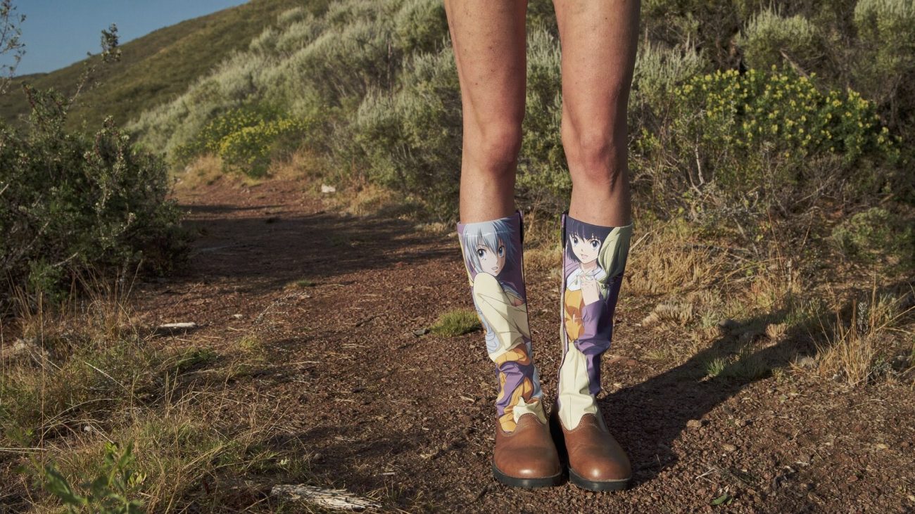 Person wearing an anime-inspired leather mountain boots in an editorial scene