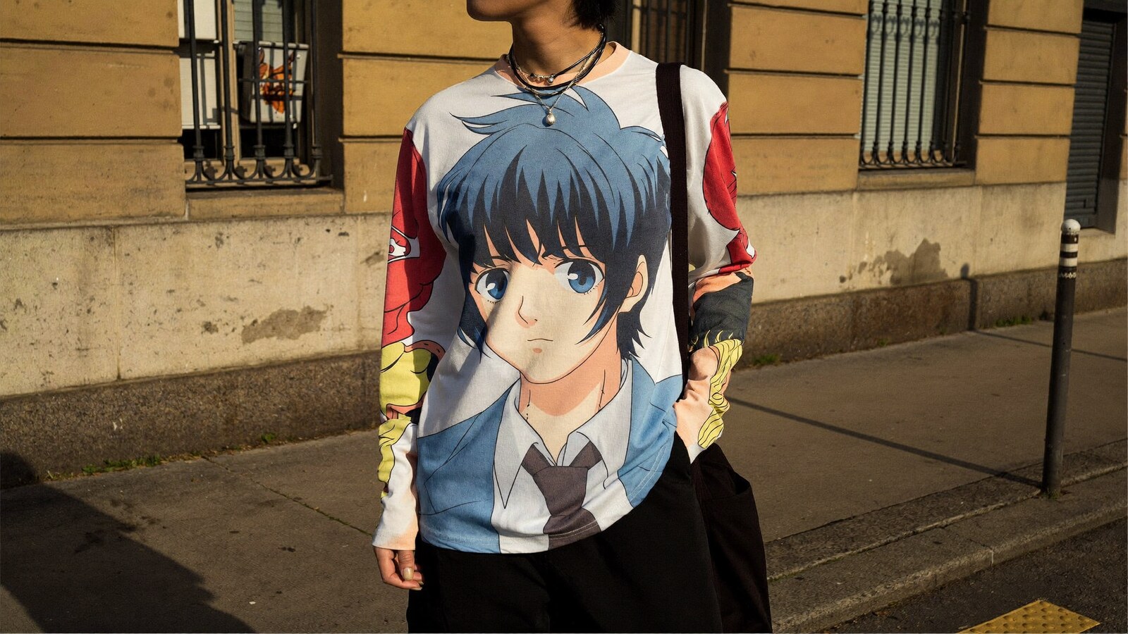 Person wearing an anime-inspired long sleeve shirts in an editorial scene