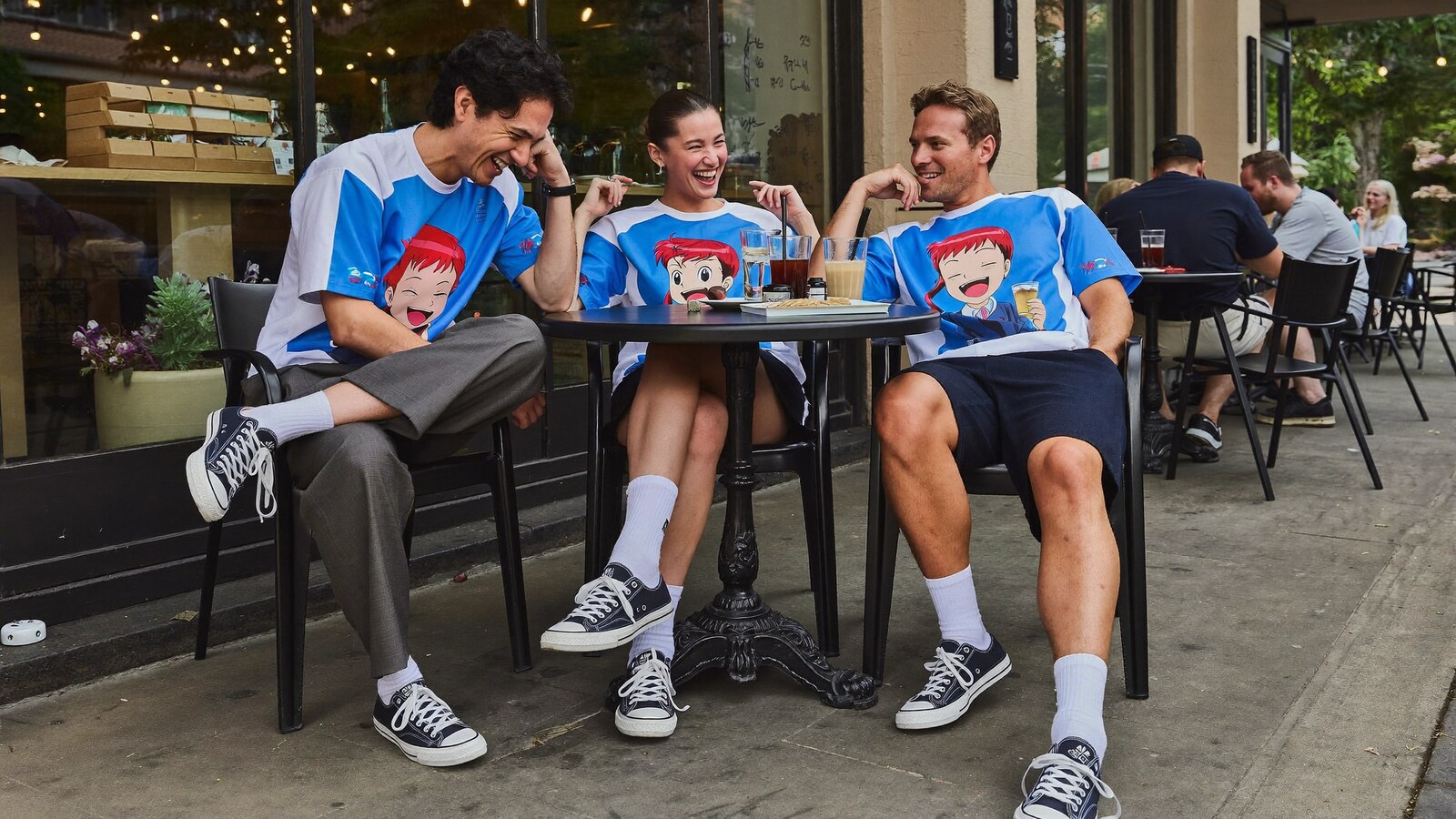 Anime-inspired low top canvas shoes in a social or layered scene with friends