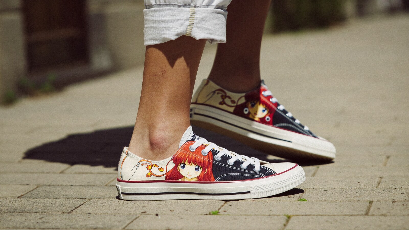Person wearing an anime-inspired low top canvas shoes in an editorial scene