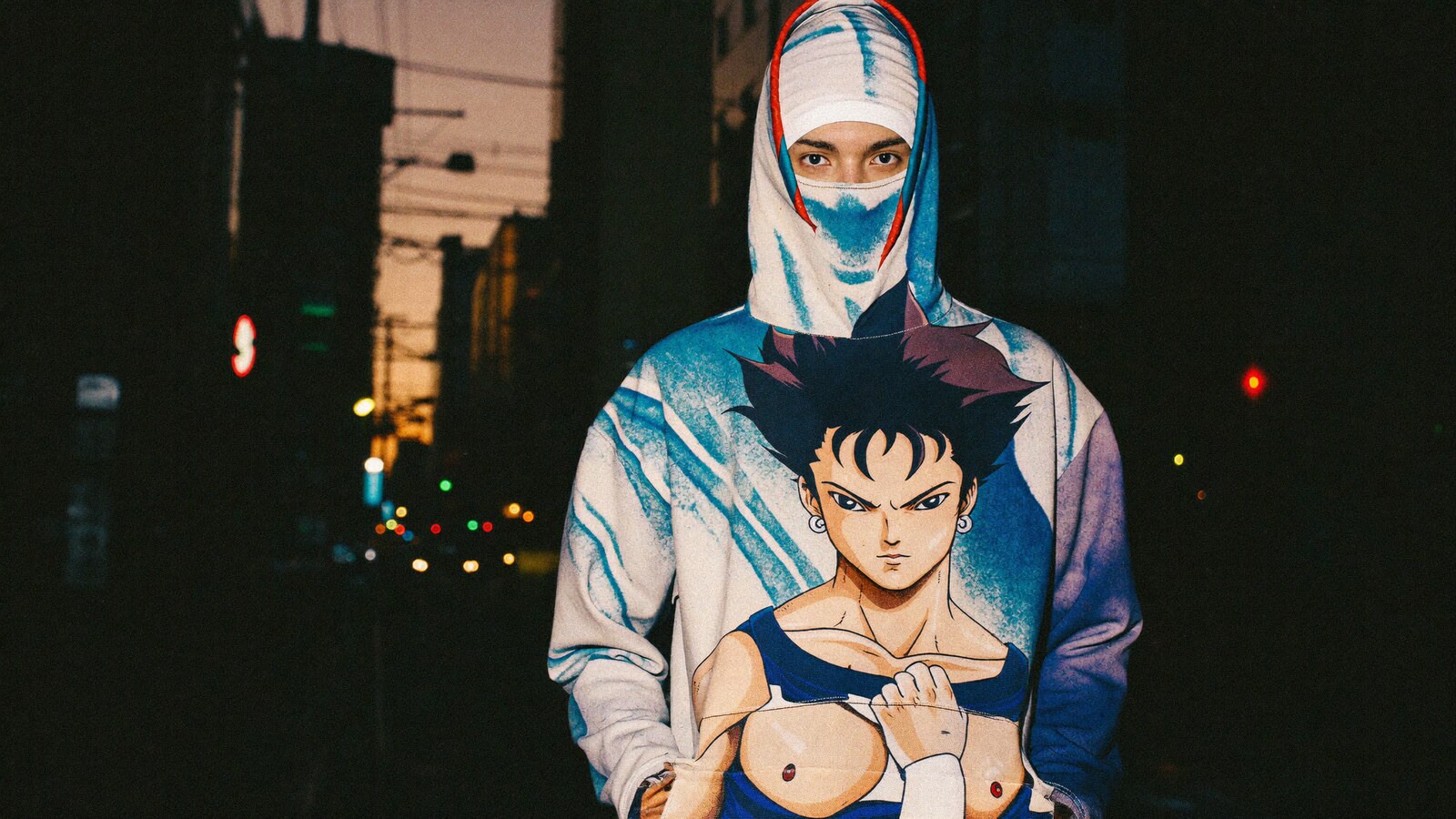 Person wearing an anime-inspired masked hoodie in an editorial scene