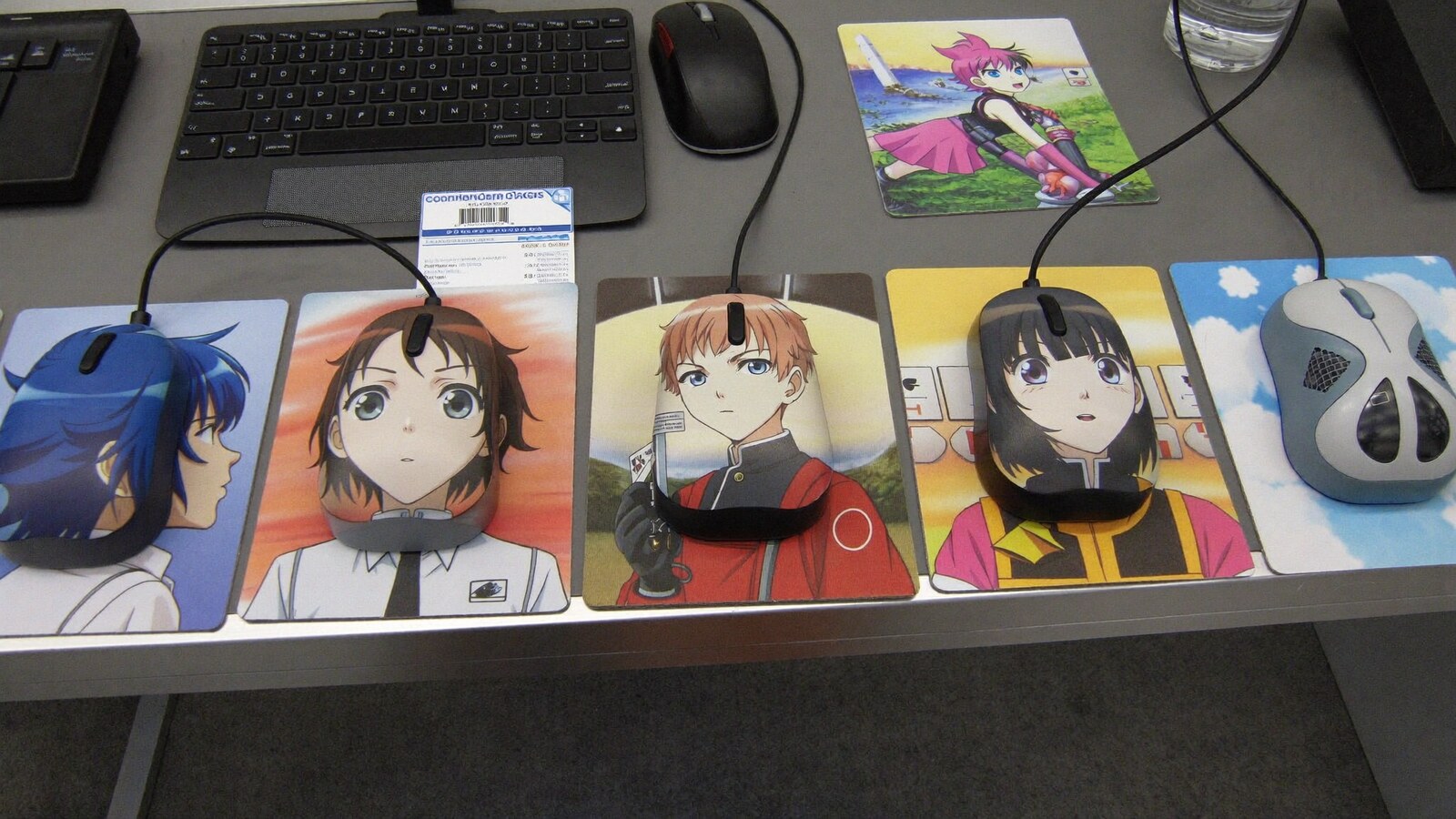 Anime-inspired mouse mats in a social or layered scene with friends