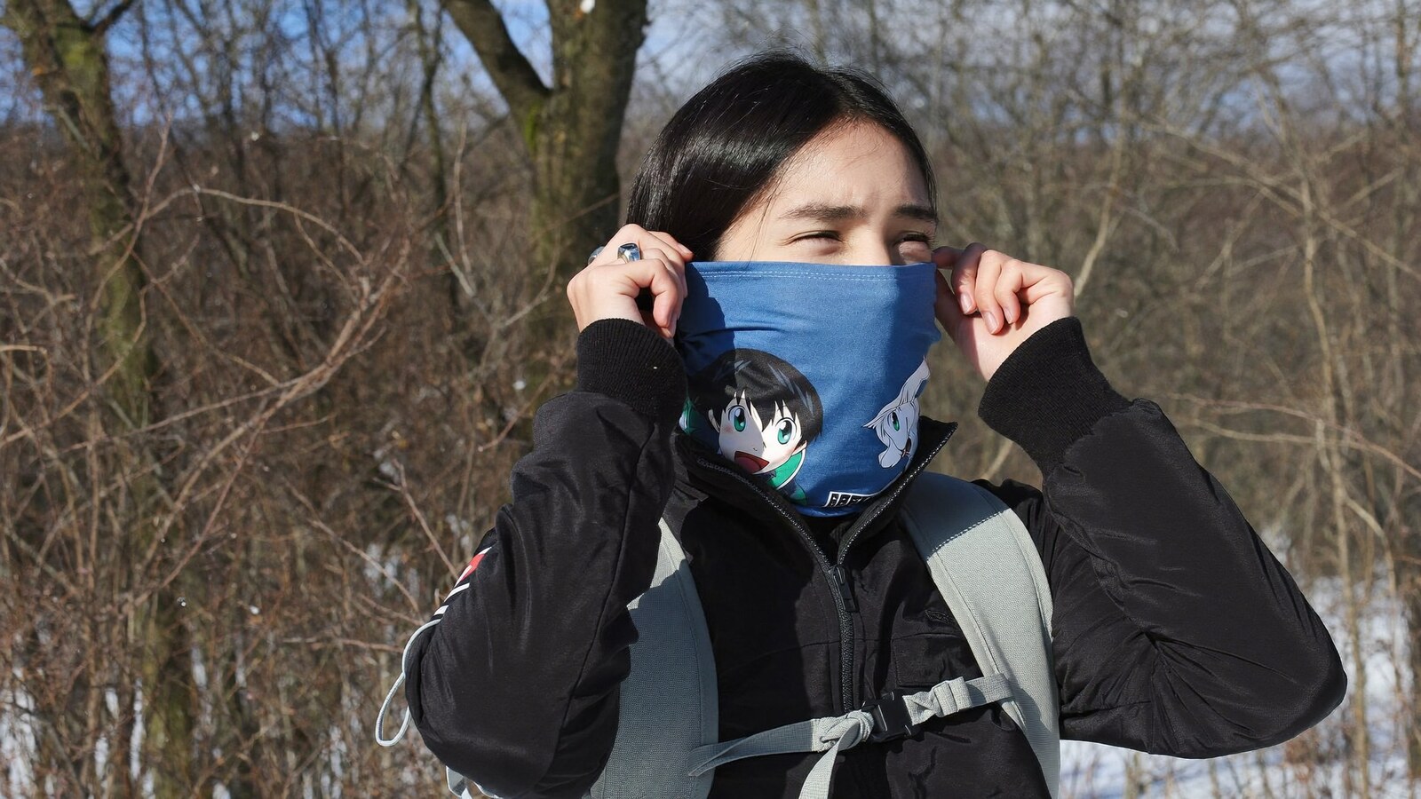 Person wearing an anime-inspired neck gaiters in an editorial scene