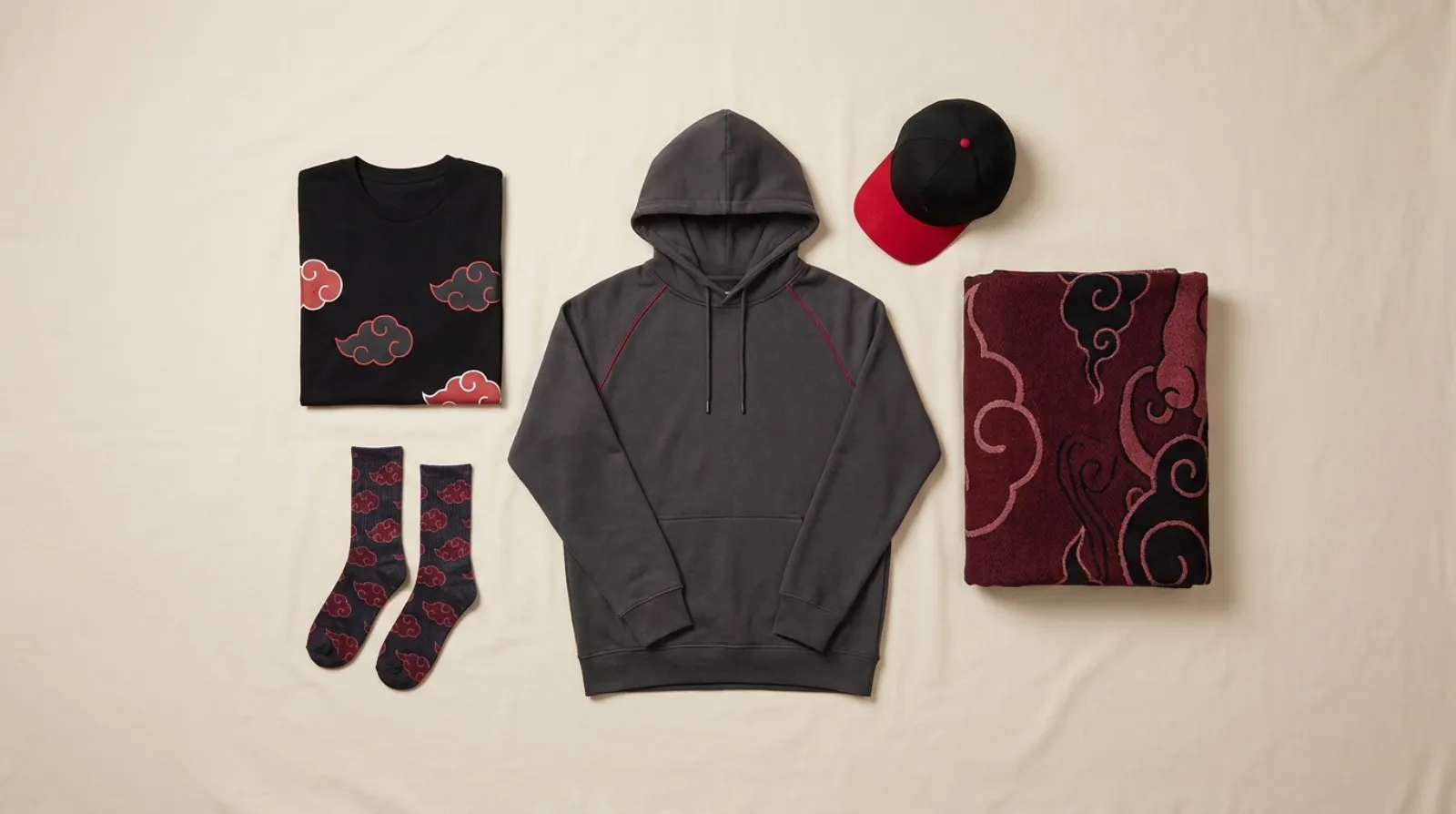 Red and black Pain shirt, hoodie, cap, and socks Akatsuki apparel flat-lay on light wood