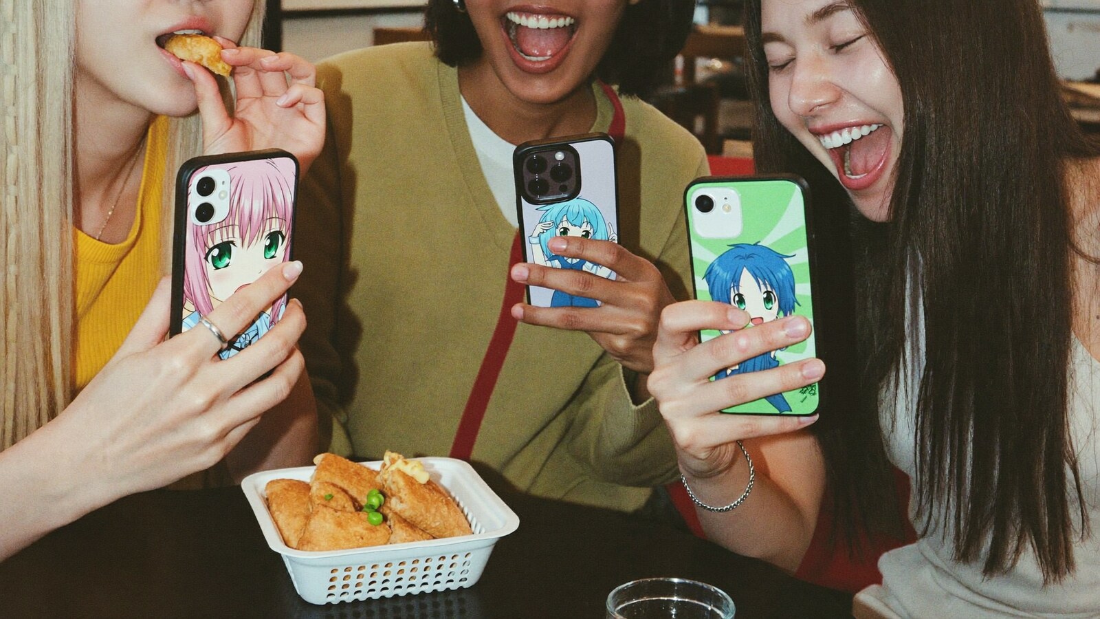 Anime-inspired phone case in a social or layered scene with friends