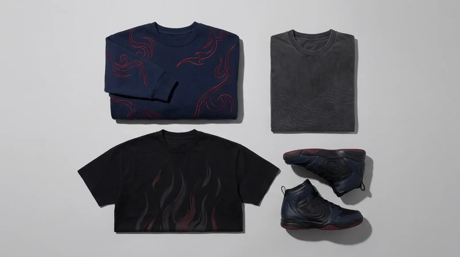 Flat-lay of Sasuke Uchiha merch including an embroidered sweatshirt, vintage tees and basketball sneakers in navy, black and crimson tones