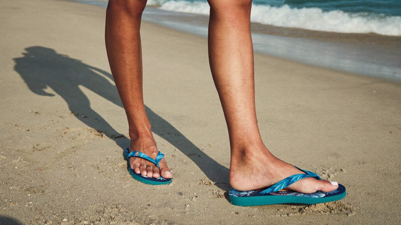 Person wearing an anime-inspired flip flops in an editorial scene