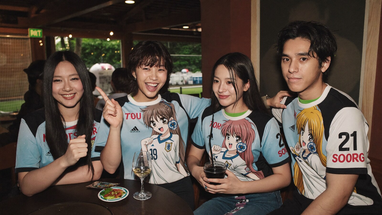 Anime-inspired soccer jersey in a social or layered scene with friends