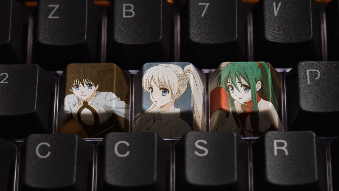 Person wearing an anime-inspired spacebar keycap in an editorial scene