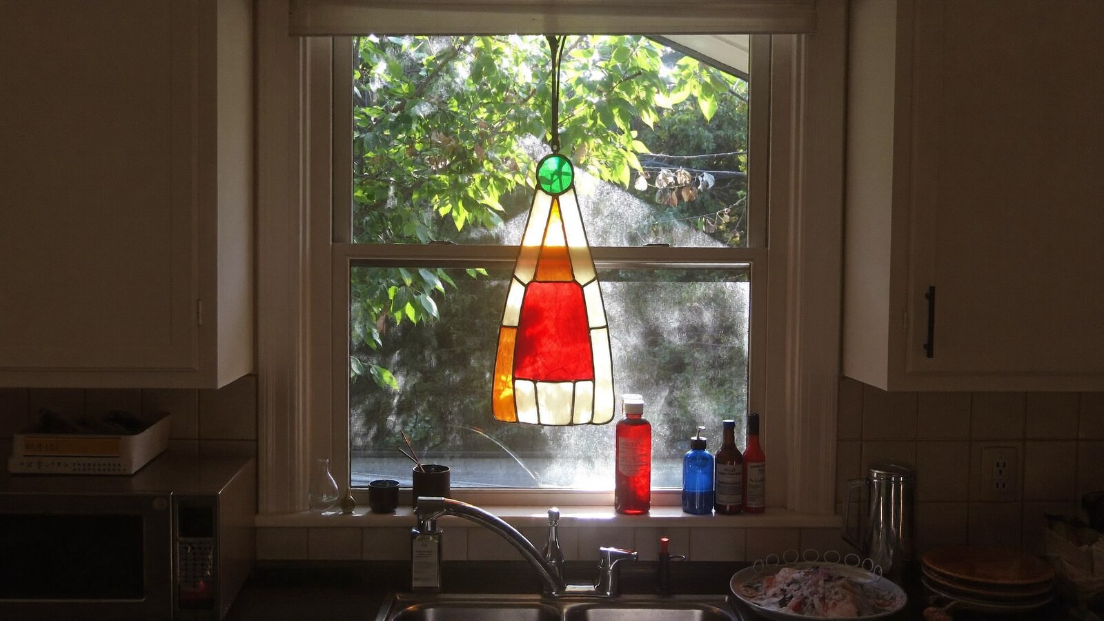 Anime-inspired stained glass ornaments styled in a natural daylight scene