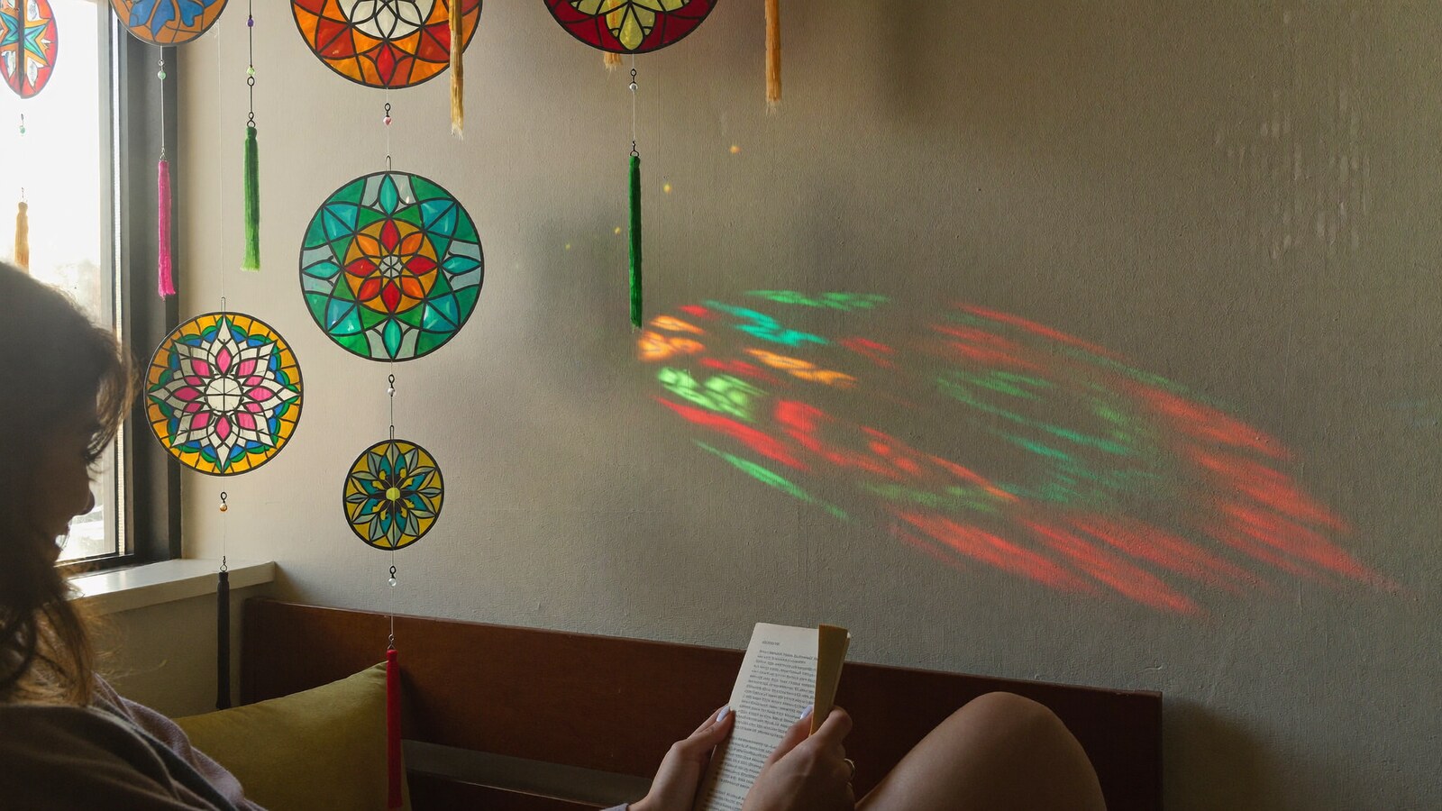 Anime-inspired stained glass suncatchers in a social or layered scene with friends