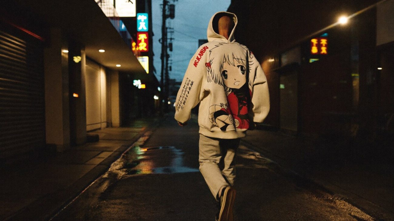 Person wearing an anime-inspired streetwear hoodies in an editorial scene