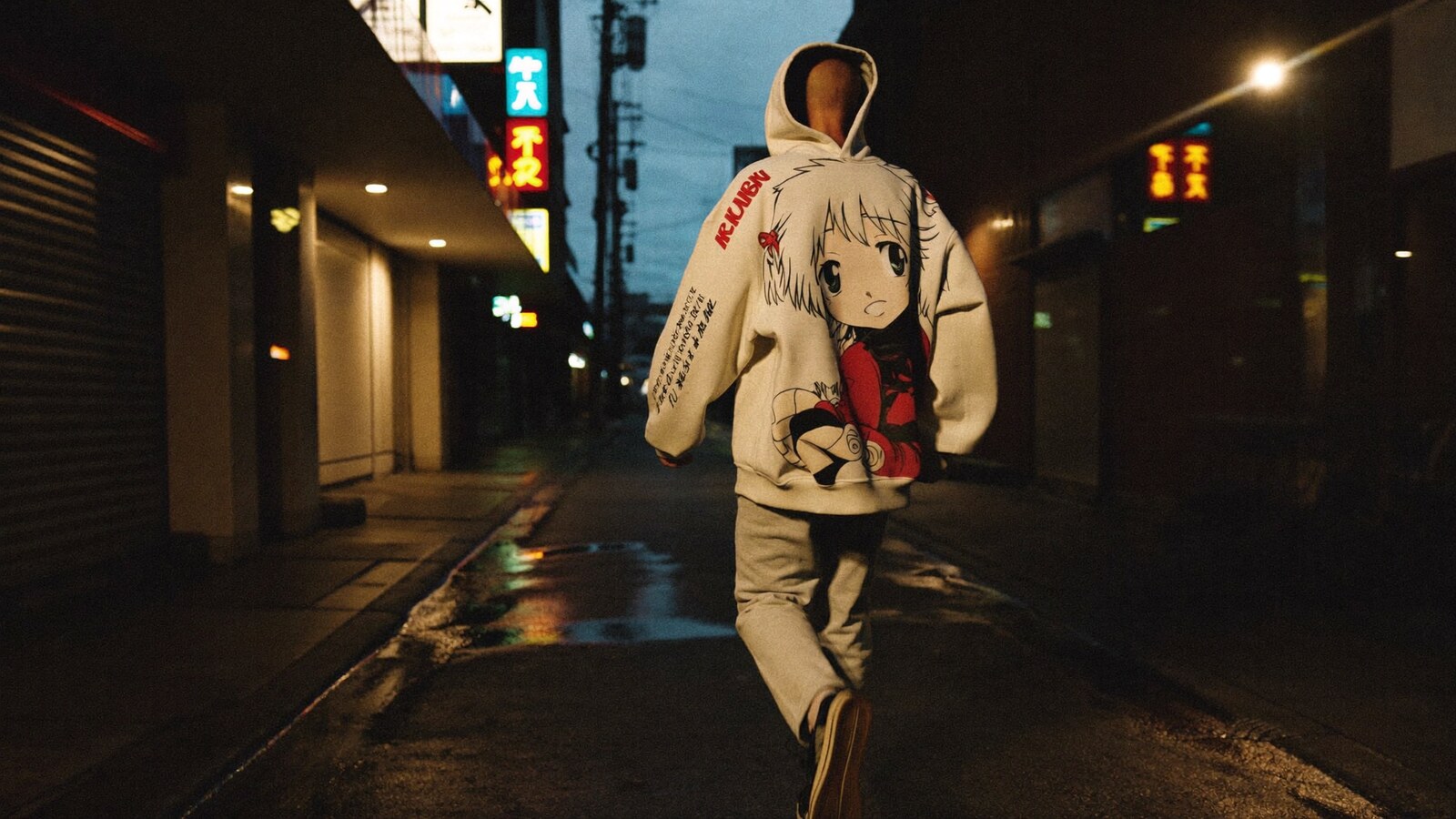 Person wearing an anime-inspired streetwear hoodies in an editorial scene