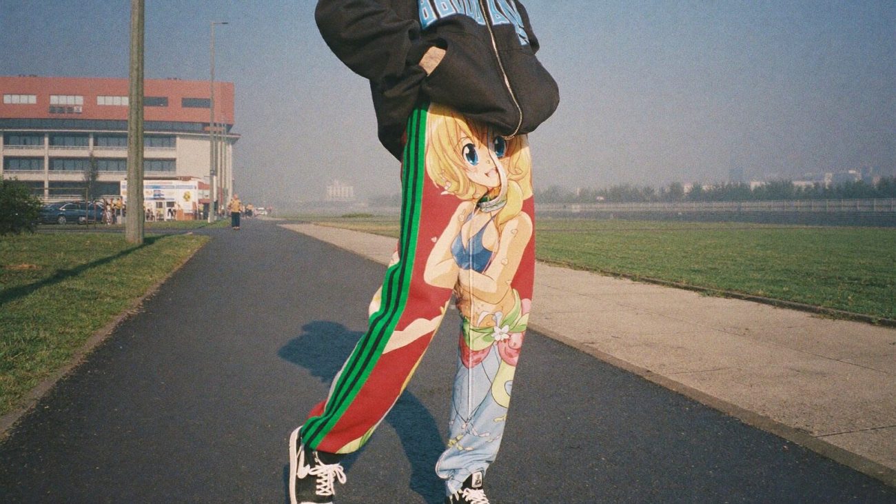 Person wearing an anime-inspired streetwear sweatpants in an editorial scene