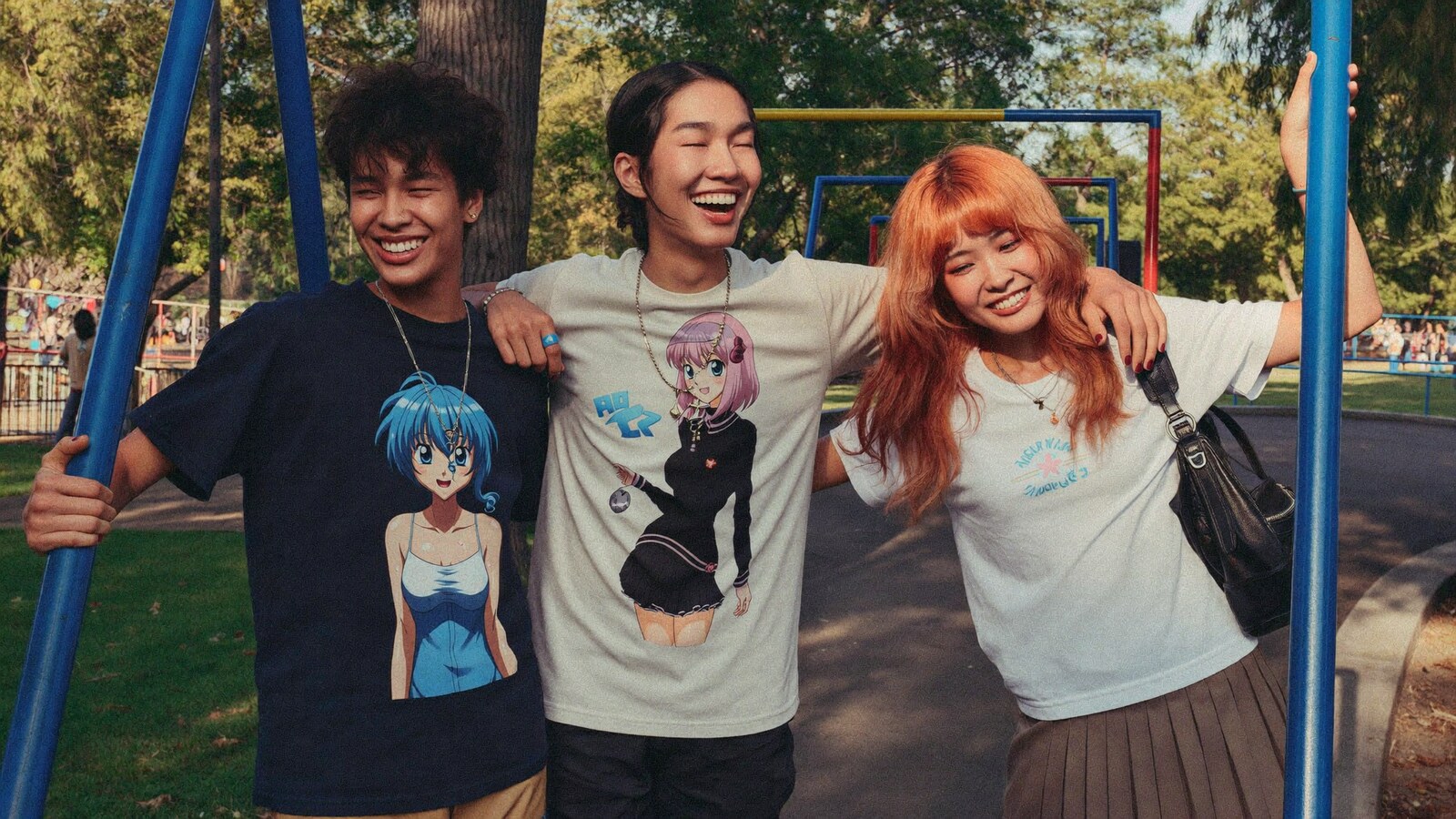Anime-inspired streetwear t-shirts in a social or layered scene with friends