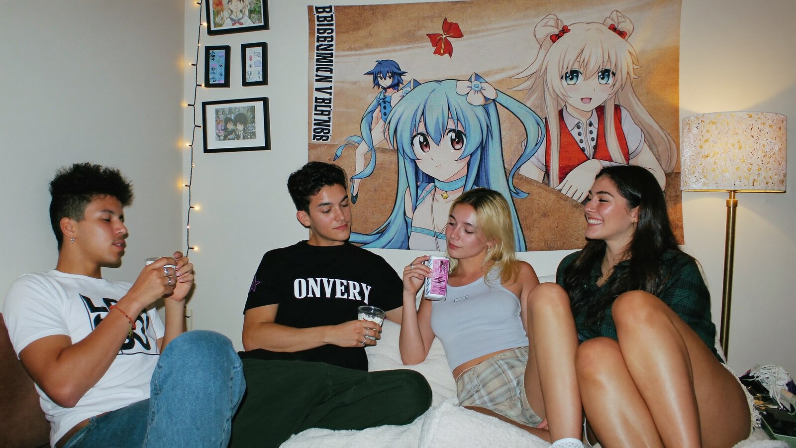 Anime-inspired tapestries in a social or layered scene with friends