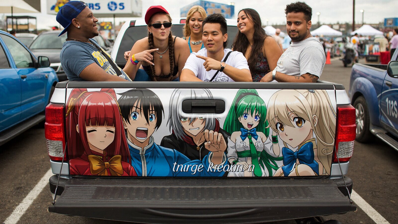 Anime-inspired truck tailgate decals in a social or layered scene with friends