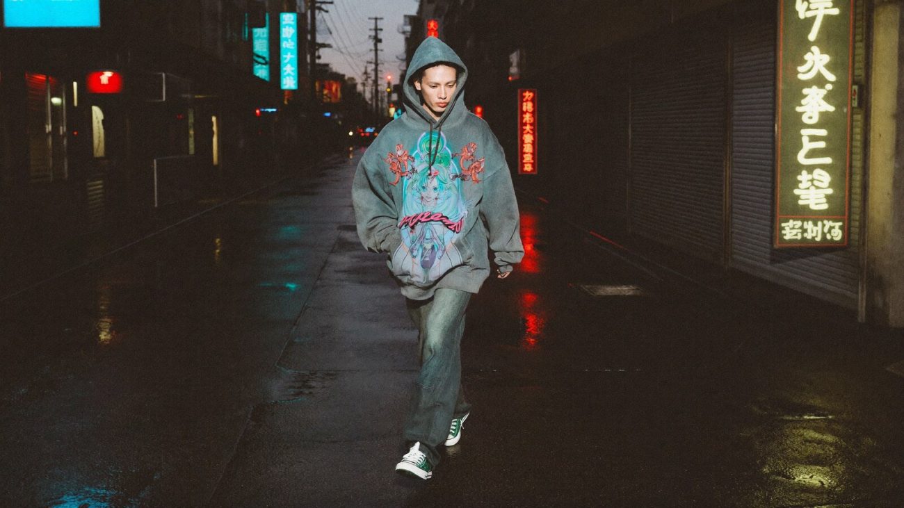 Person wearing an anime-inspired vintage hoodie in an editorial scene