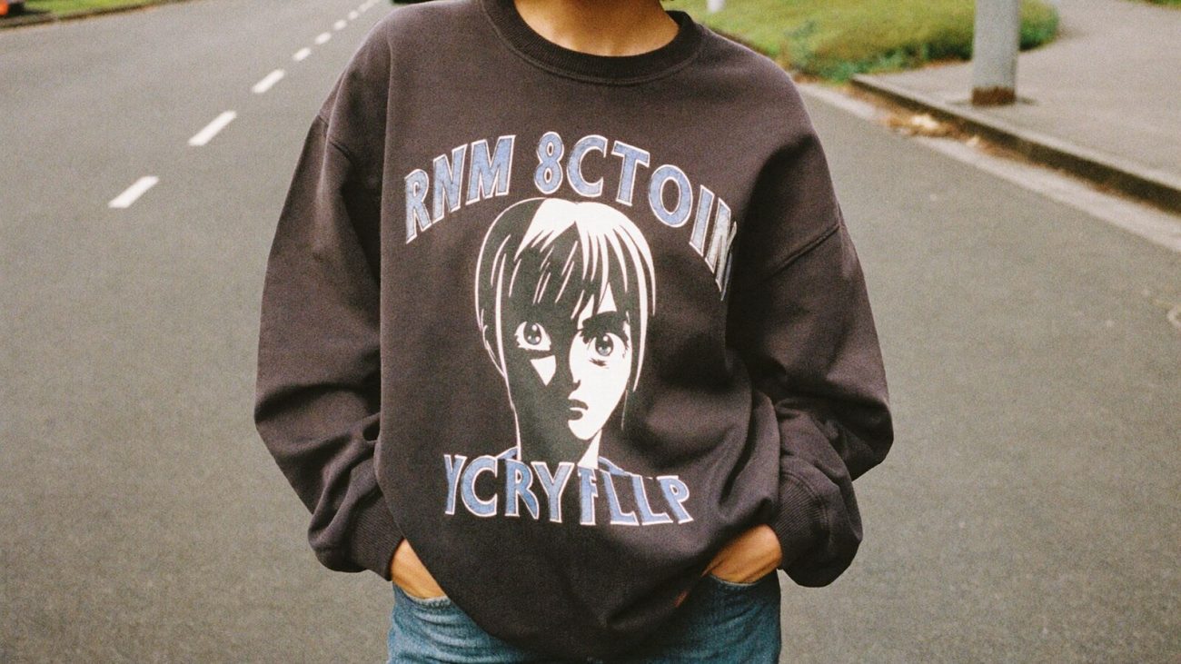 Person wearing an anime-inspired vintage sweatshirts in an editorial scene