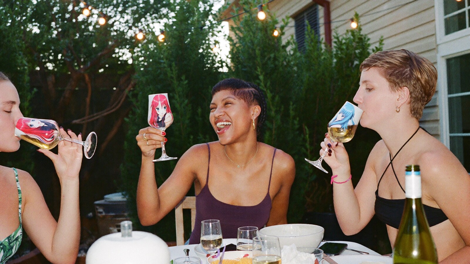 Anime-inspired wine tumbler in a social or layered scene with friends