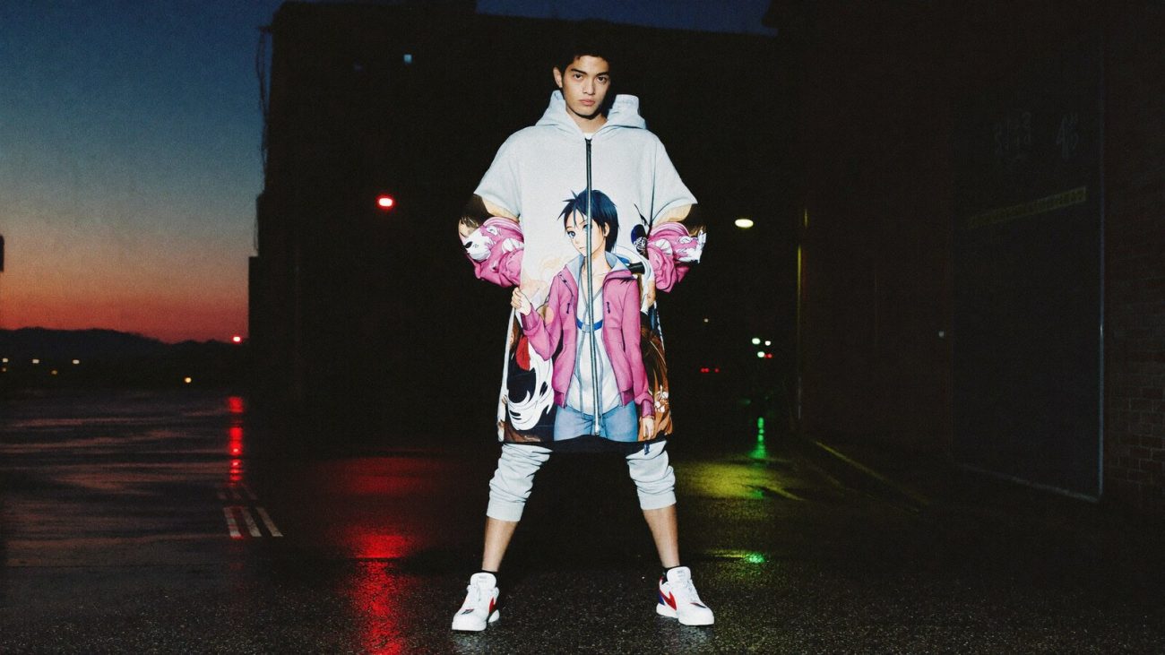 Person wearing an anime-inspired zip hoodie jackets in an editorial scene