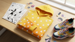 Demon Slayer Zenitsu themed hoodie flat lay in bright yellow triangle pattern