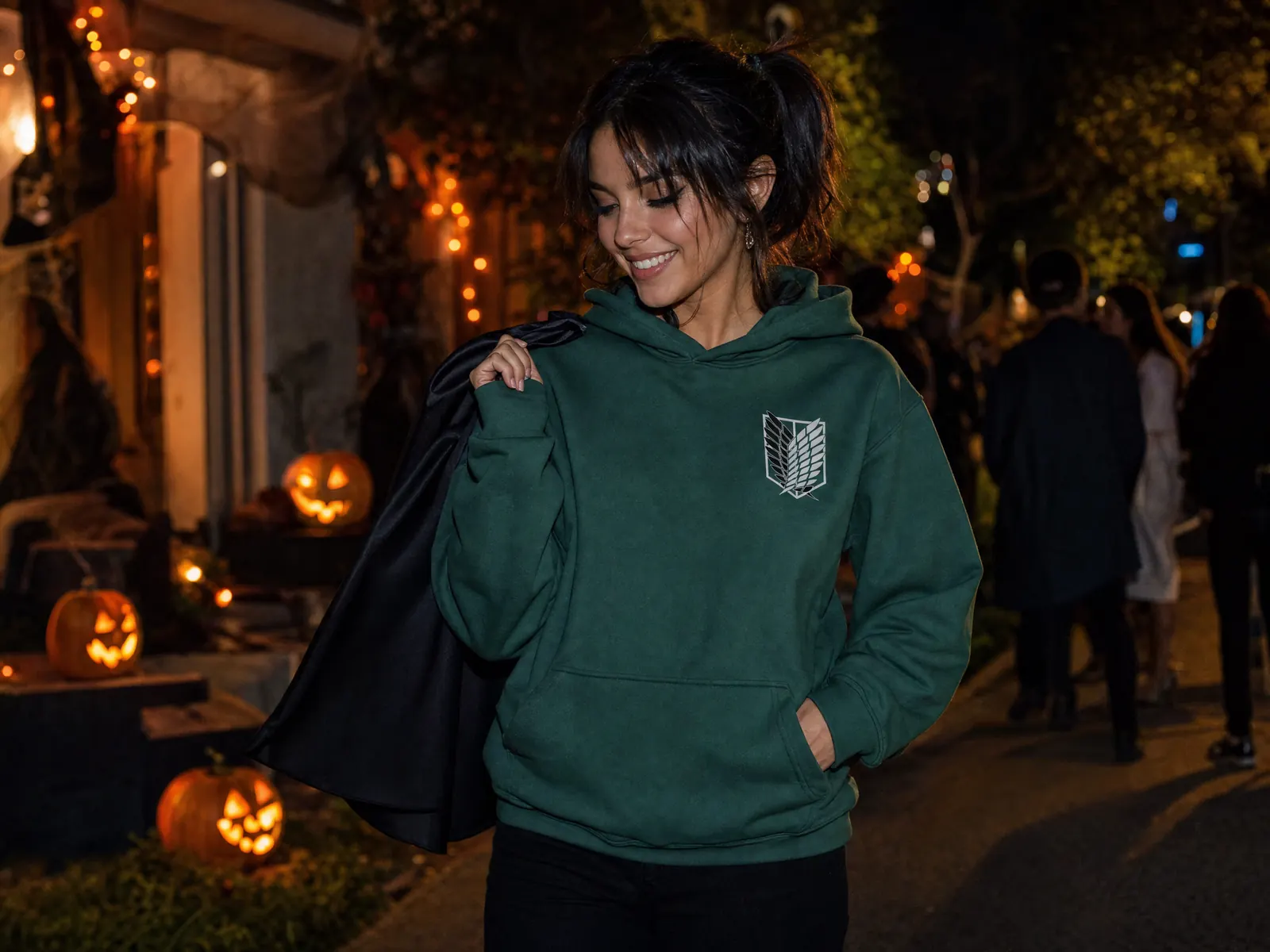 Woman at a Halloween party wearing the Attack on Titan Wings of Liberty cosplay hoodie as a costume